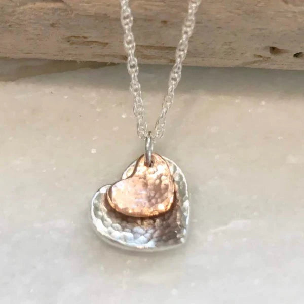 Necklace with a heart-shaped pendant on a light background.