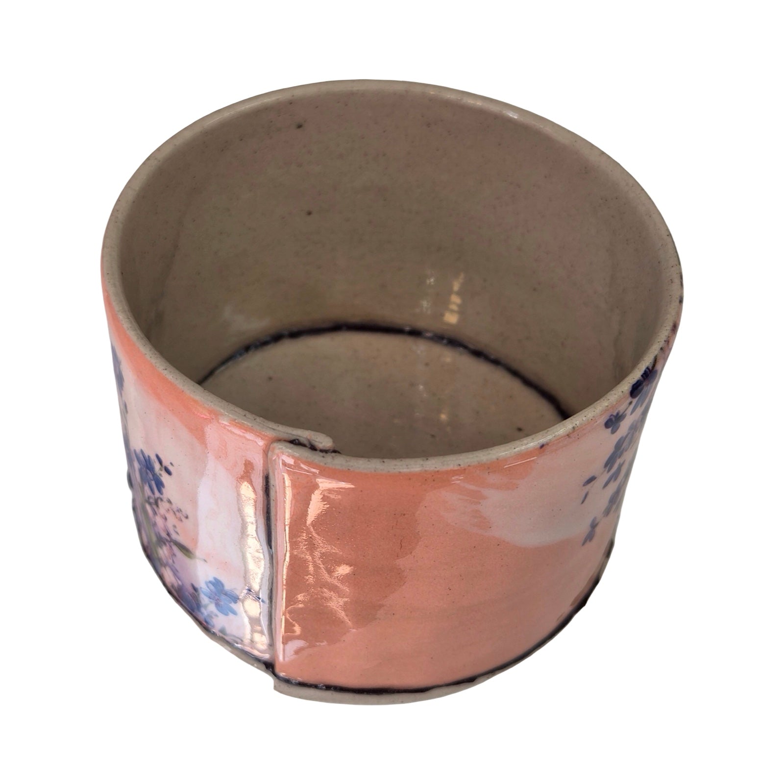 Ceramic planter with floral design on a white background.
