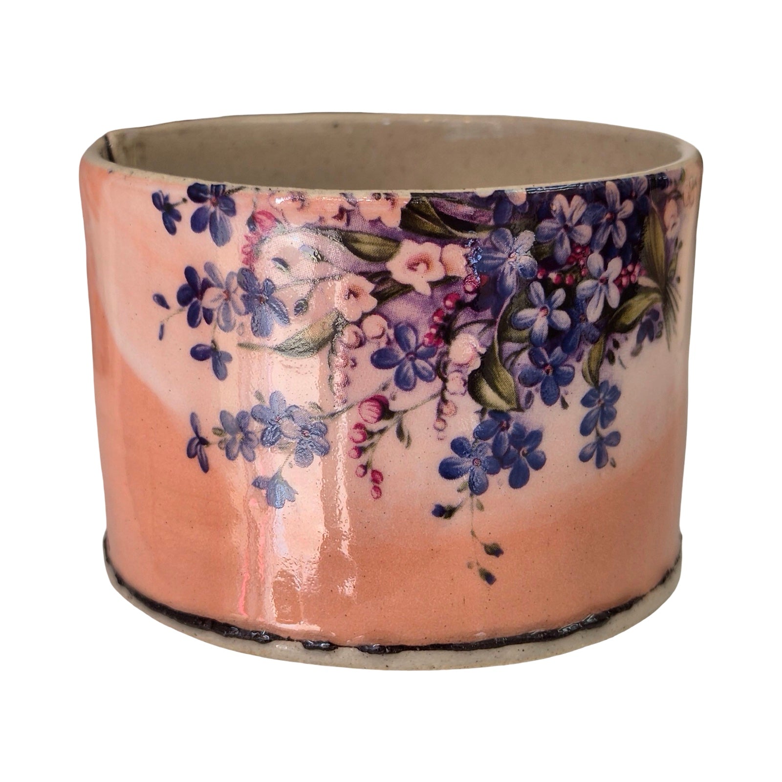 Ceramic planter with floral design on a white background.