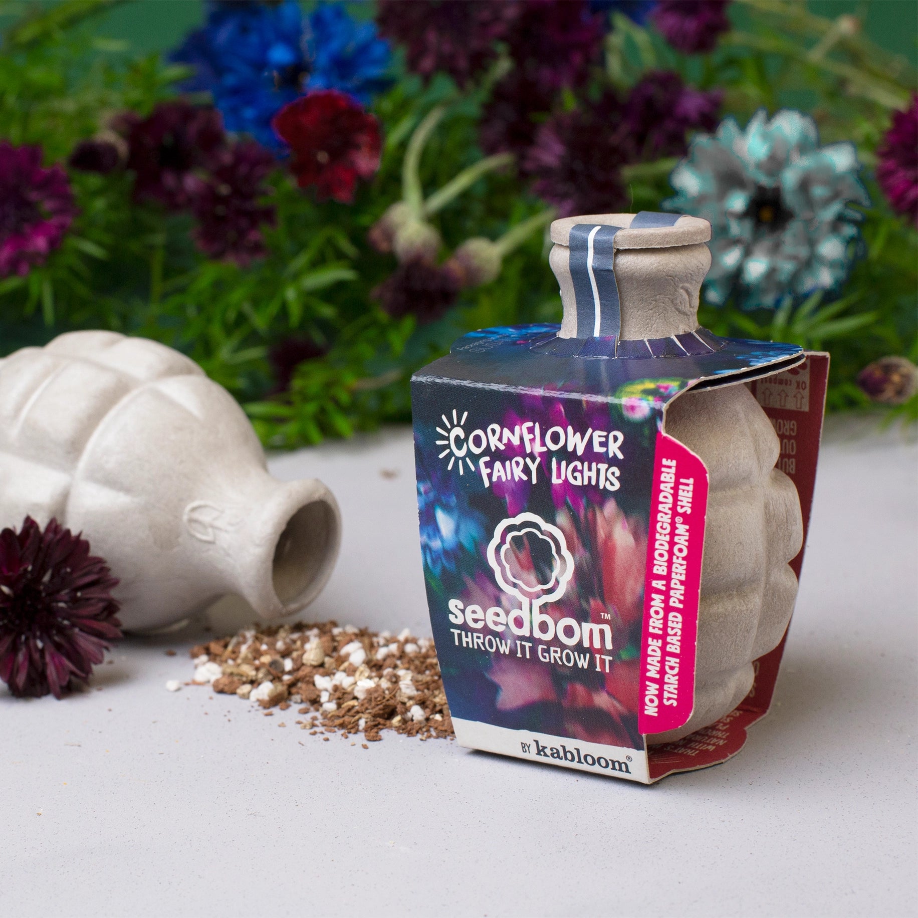 Seedbomb packaging with decorative elements on a table.