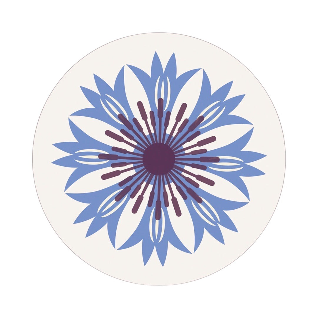 A round placemat featuring an abstract cornflower design in blue and white. 