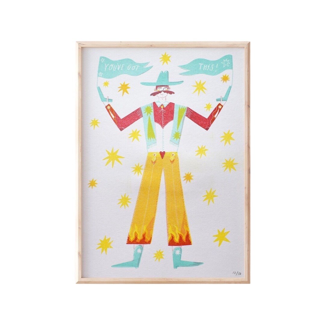 This print features an illustration of a cowboy, dressed in yellow trousers, a red shirt, a green waistcoat and a blue cowboy hat and boots.