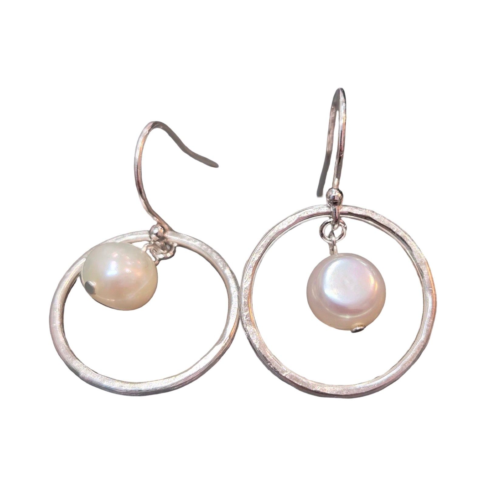 Silver hoop earrings with pearl drops on a white background.