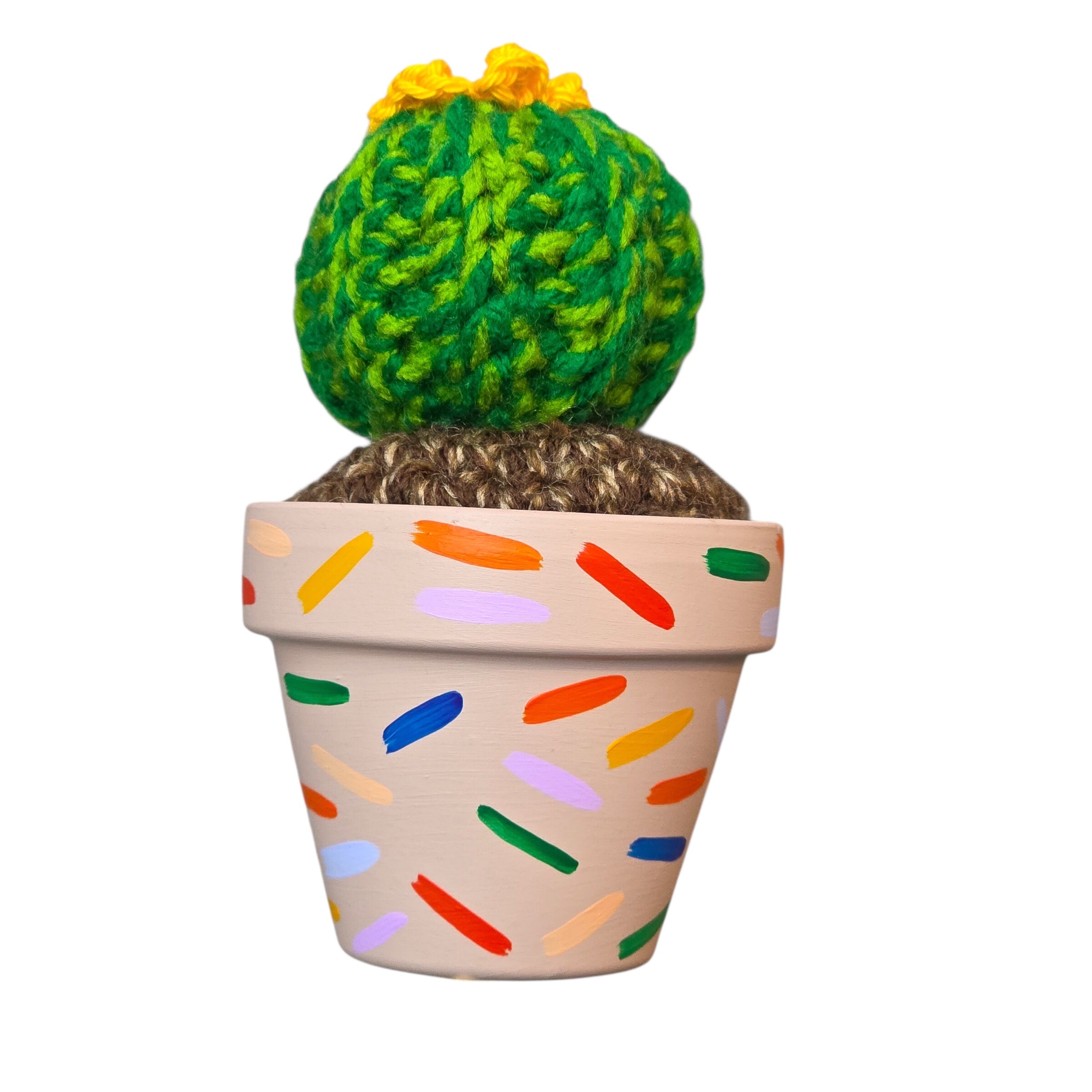 An image of a crochet cactus in a colourful handprinted pot. 