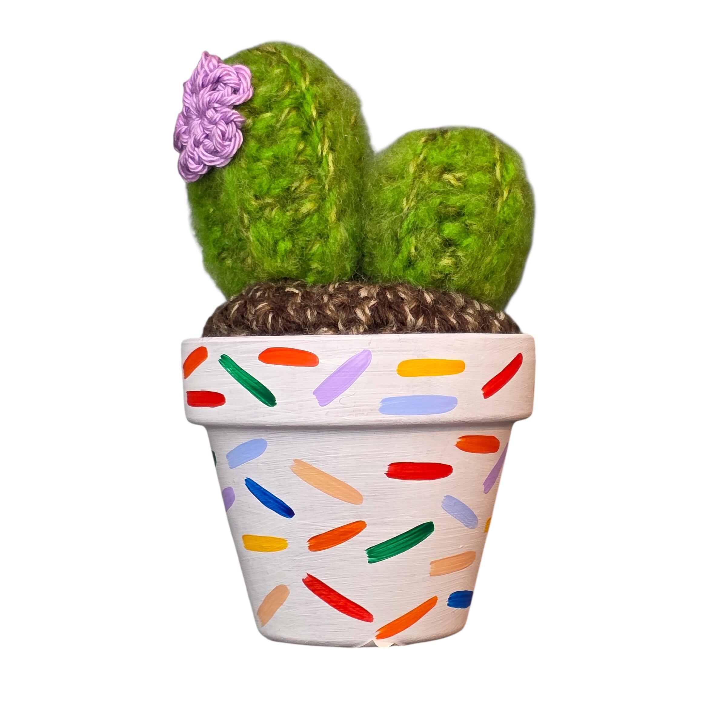 An image of a crochet cactus in a colourful handprinted pot. 