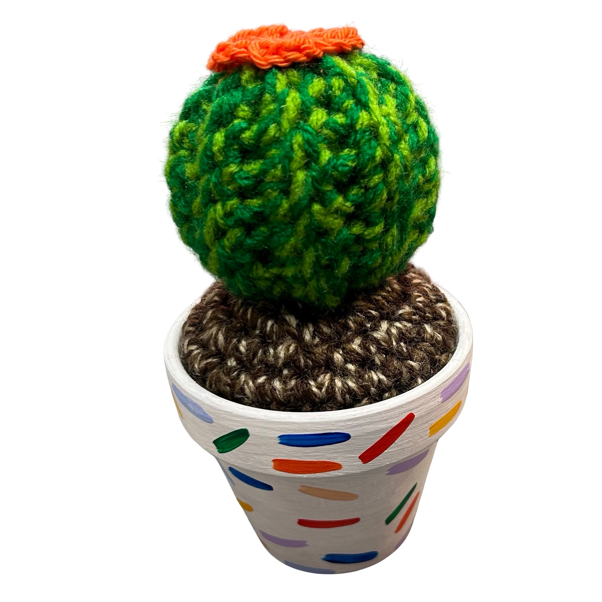 Small round crochet cactus with an orange flower in a white pot with a colourful confetti design.