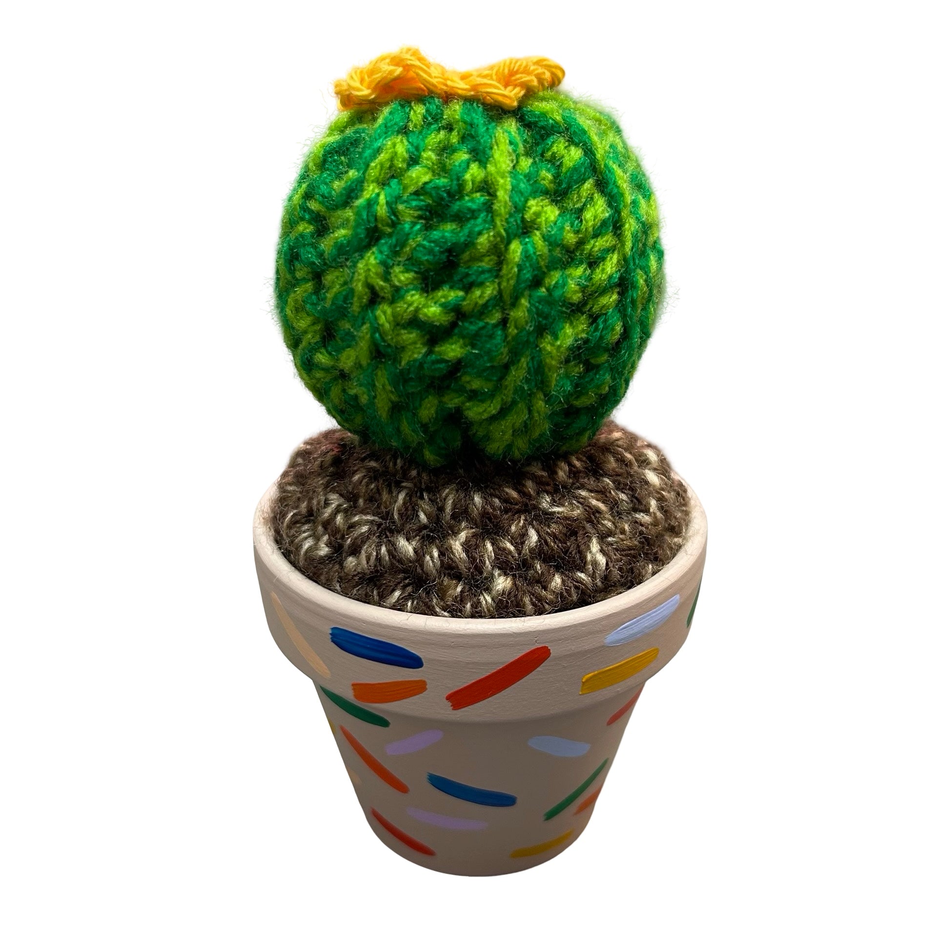 Small round crochet cactus with a yellow lower. In a mushroom coloured hand painted pot with colourful confetti design.