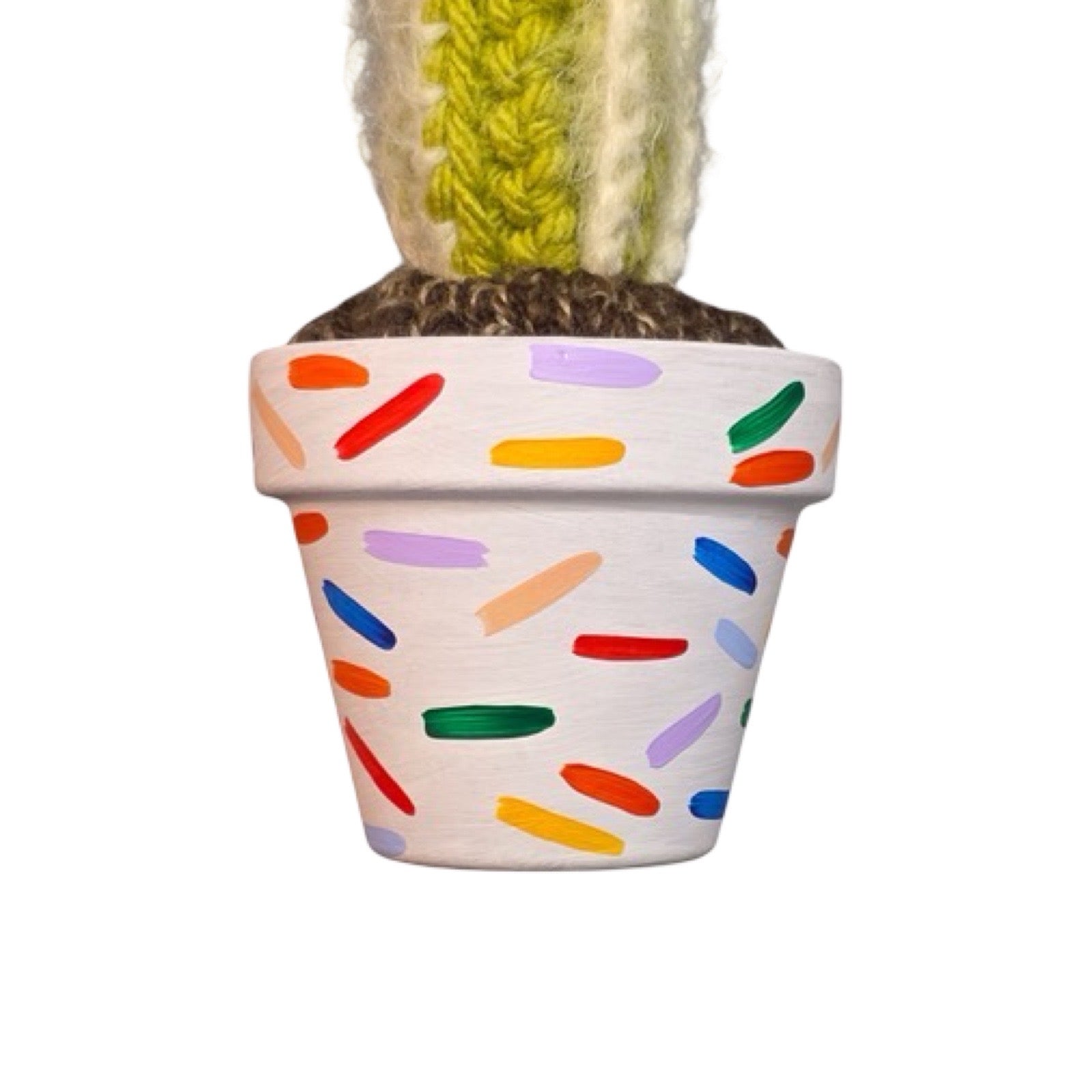 Handmade tall crochet striped cactus with a pink flower in a confetti painted white terracotta pot.