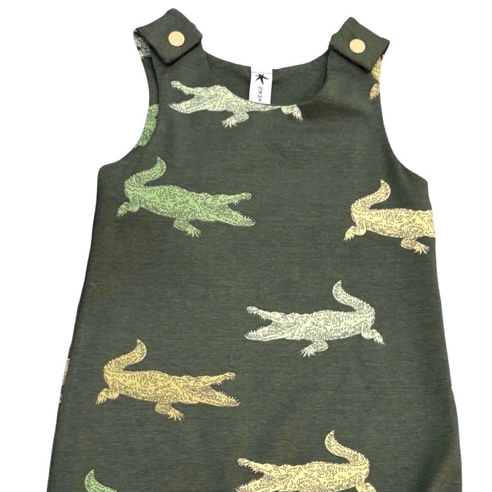 This oversized romper is patterned with green crocodiles.