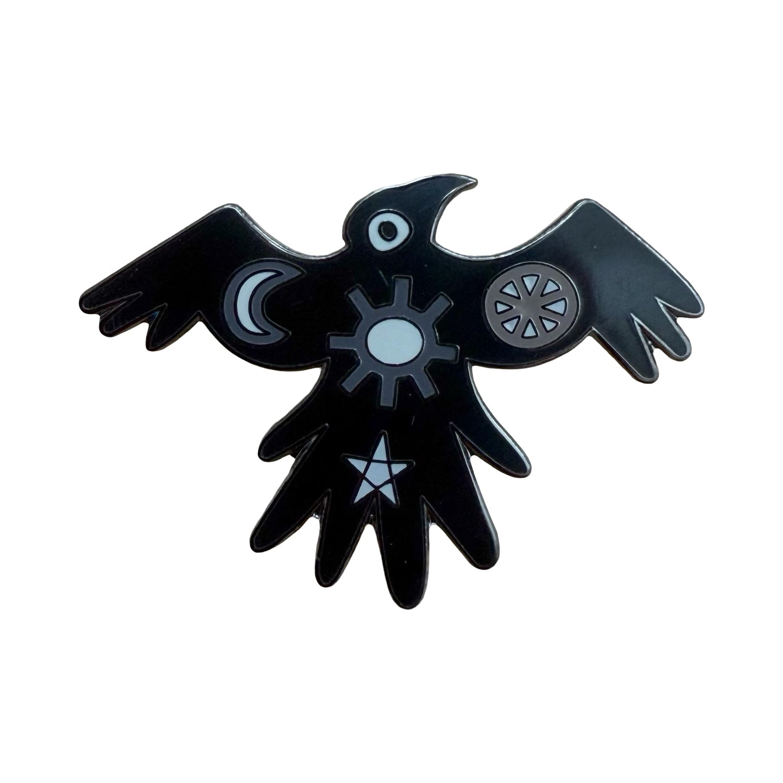 A crow-shaped enamel pin badge inspired by Pictish Symbol Stone. Each pin badge features a sun, a moon and a star. 
