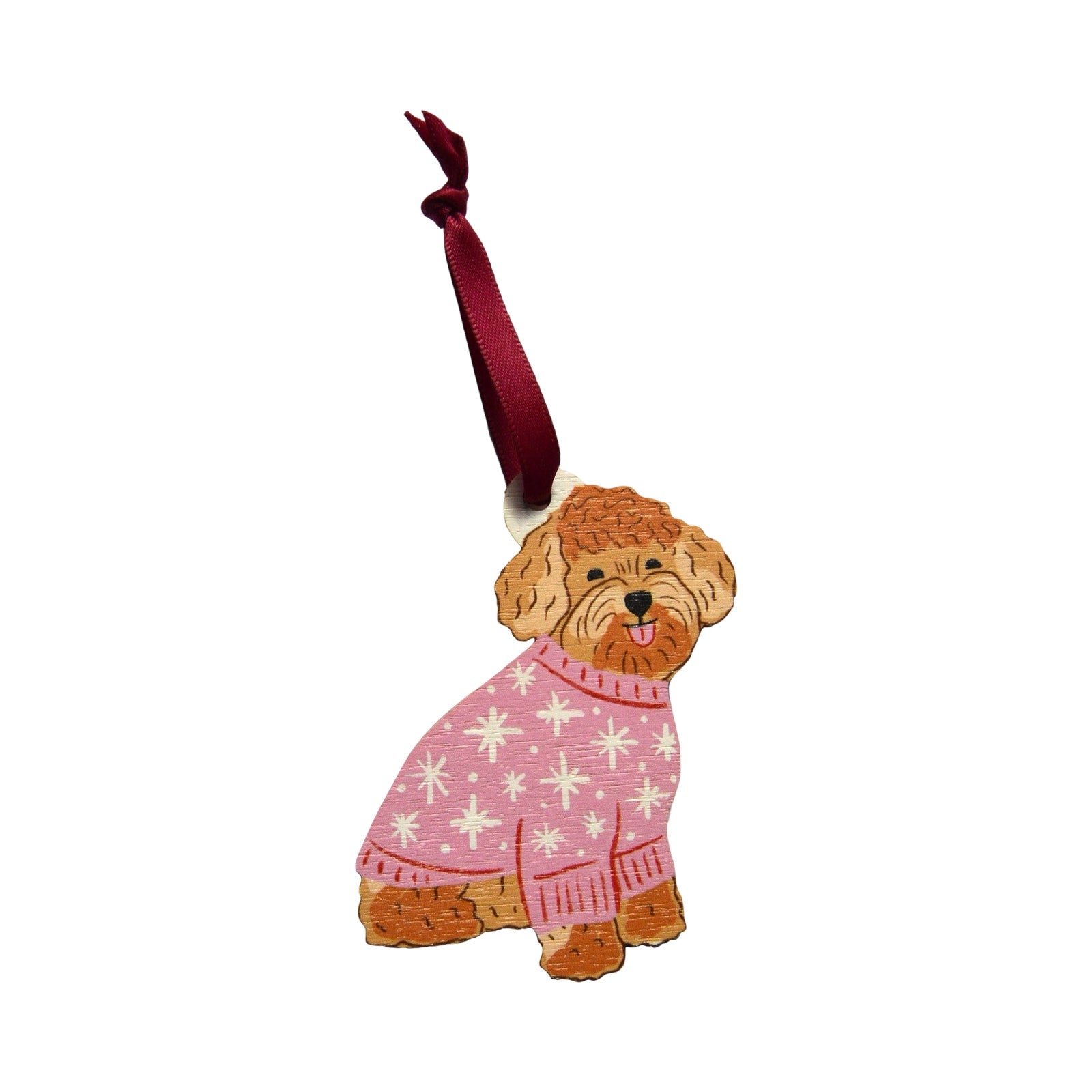 A wooden Christmas decoration of a cute cockapoo wearing a pink Christmas jumper. Each decoration is made from sustainably sourced wood and strung with a purple ribbon.