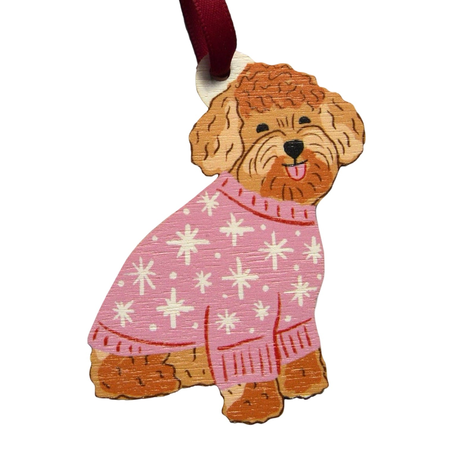 A wooden Christmas decoration of a cute cockapoo wearing a pink Christmas jumper. Each decoration is made from sustainably sourced wood and strung with a purple ribbon.