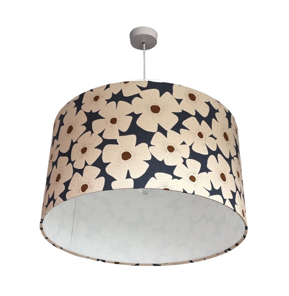 Drum lampshade covered in navy canvas fabric with white and mustard daisies.