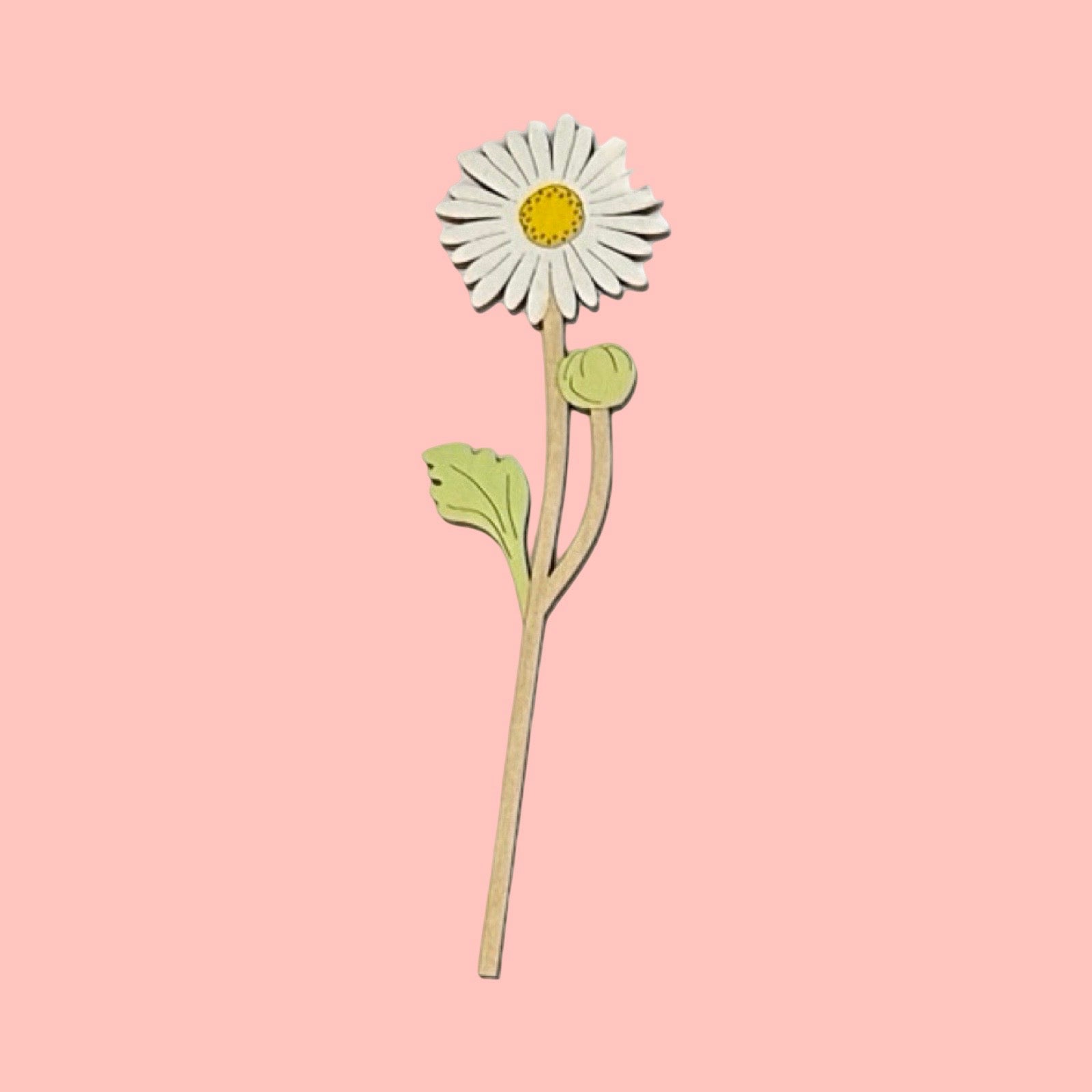 Wooden daisy flower decoration on a pink background.