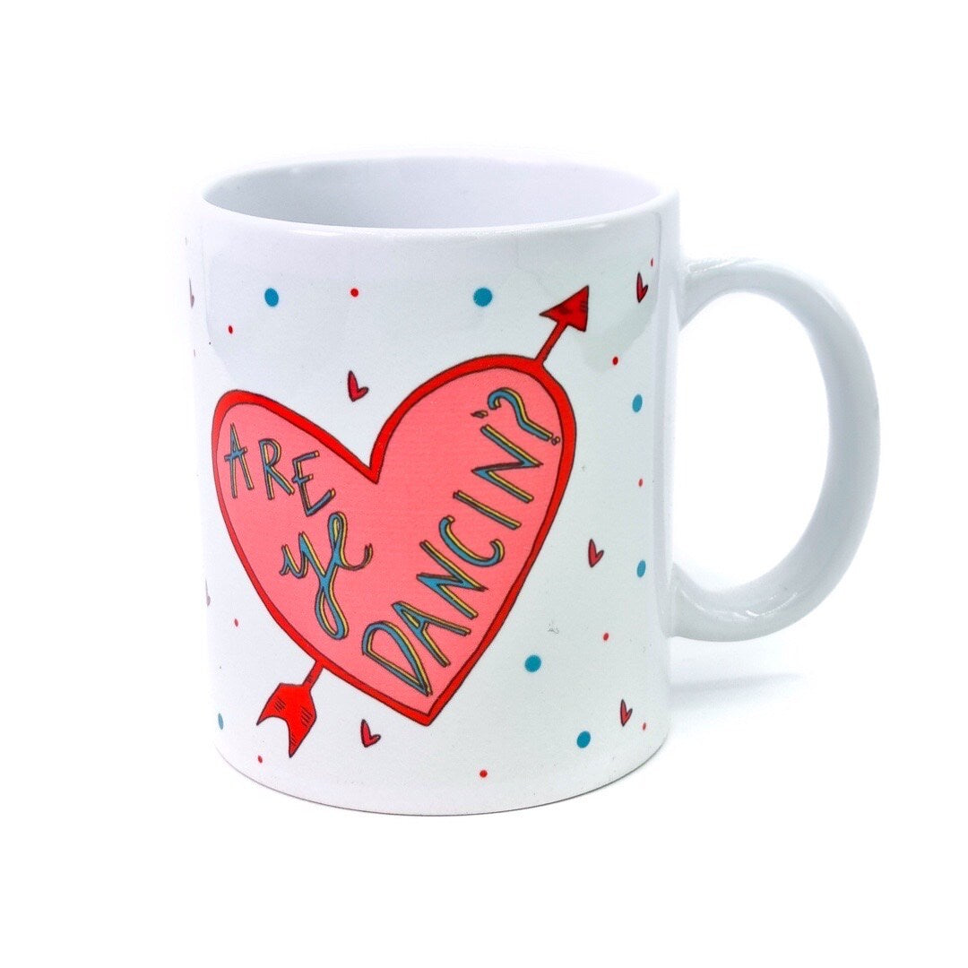 Mug featuring two love hearts with arrows through them and the text 'Are ye Dancin?' in one and 'Are ye Askin?!' in the other.
