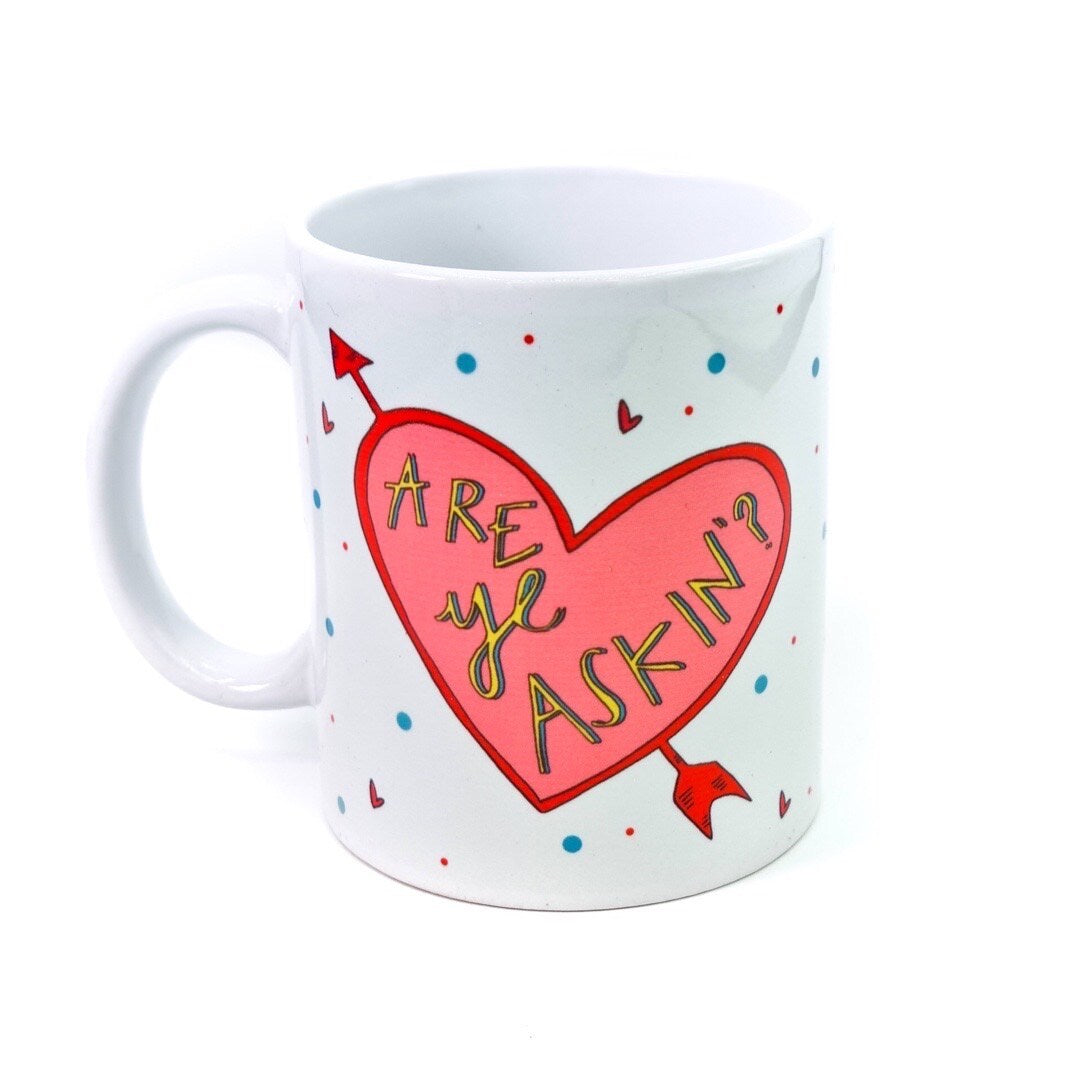 Mug featuring two love hearts with arrows through them and the text 'Are ye Dancin?' in one and 'Are ye Askin?!' in the other.