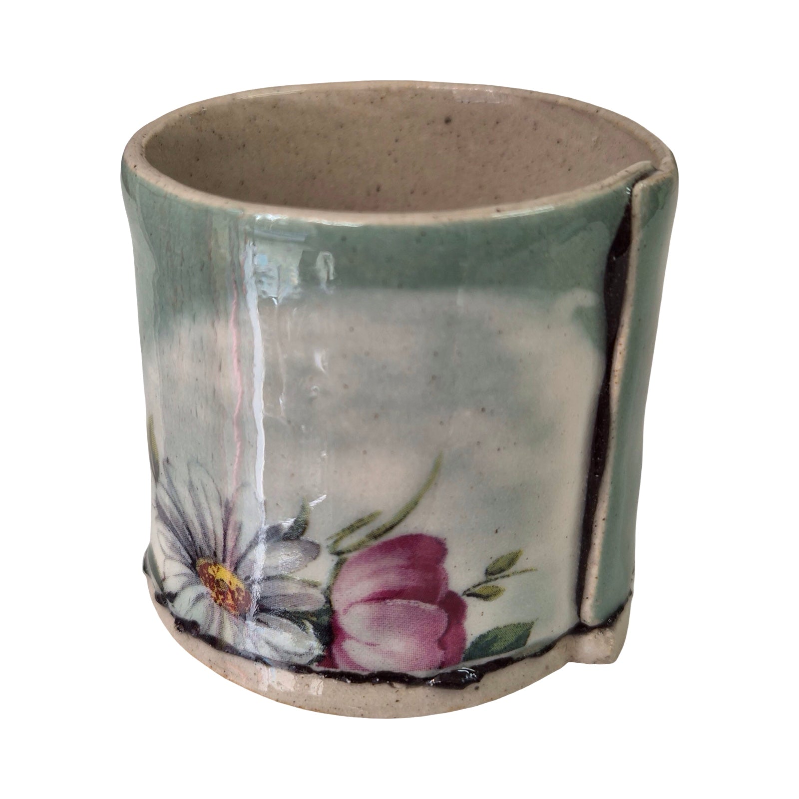 Ceramic green planter with floral design on a white background.