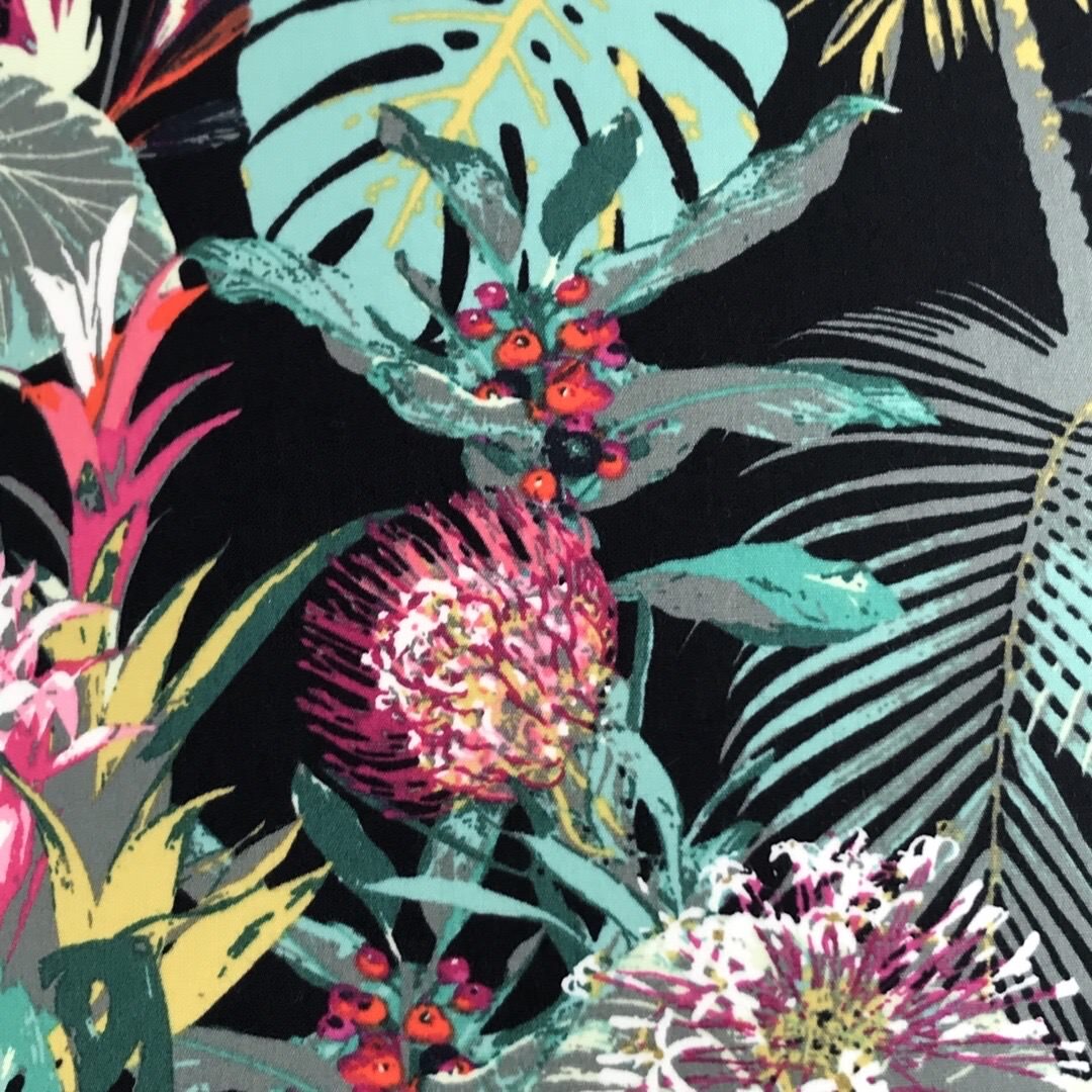 Dark fabric with bright tropical flowers and leaves