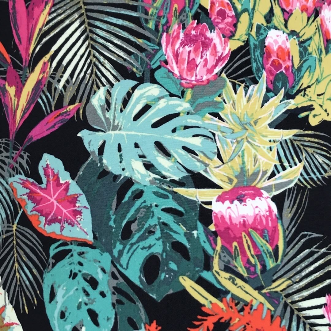 Dark fabric with bright tropical flowers and leaves