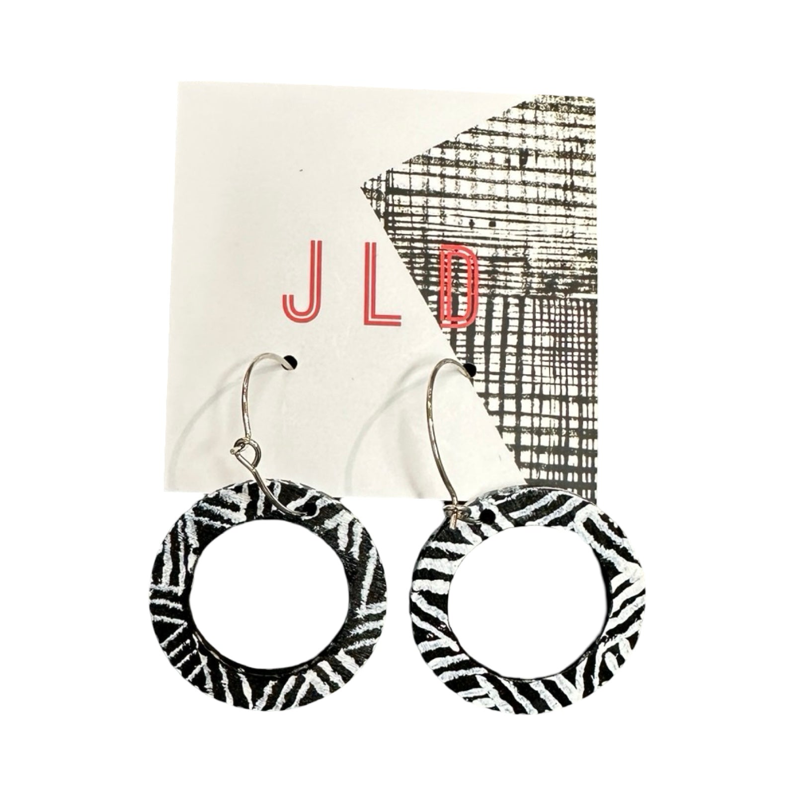 Black and white patterned earrings on a JLD branded card.