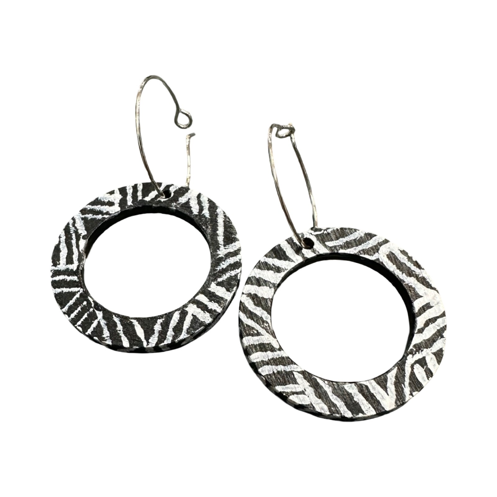 Zebra print hoop earrings on a white background.