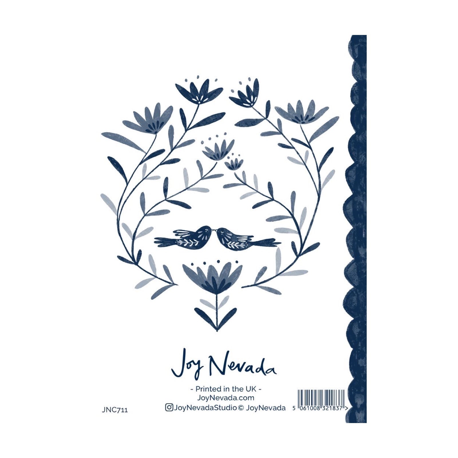 The back of a greeting card with two love birds surround by flowers and foliage, all in navy, and a navy scalloped spine, all against a white background.