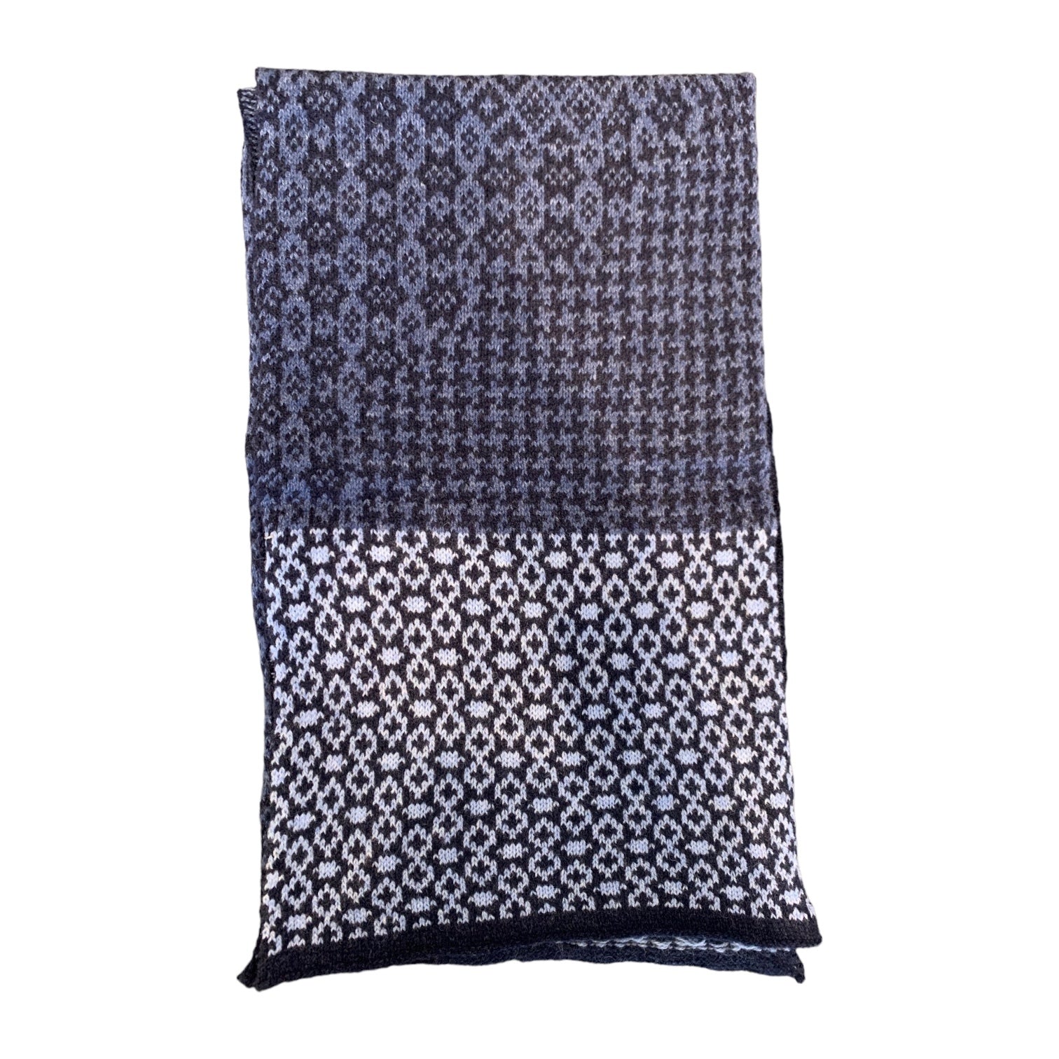A cosy and soft 100% lambswool knitted scarf with a denim blue, white and black geometric design.