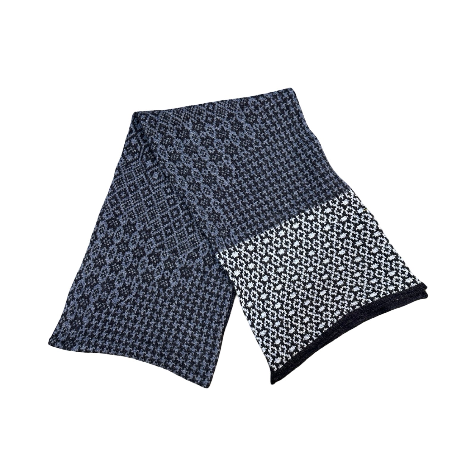 A cosy and soft 100% lambswool knitted scarf with a denim blue, white and black geometric design.