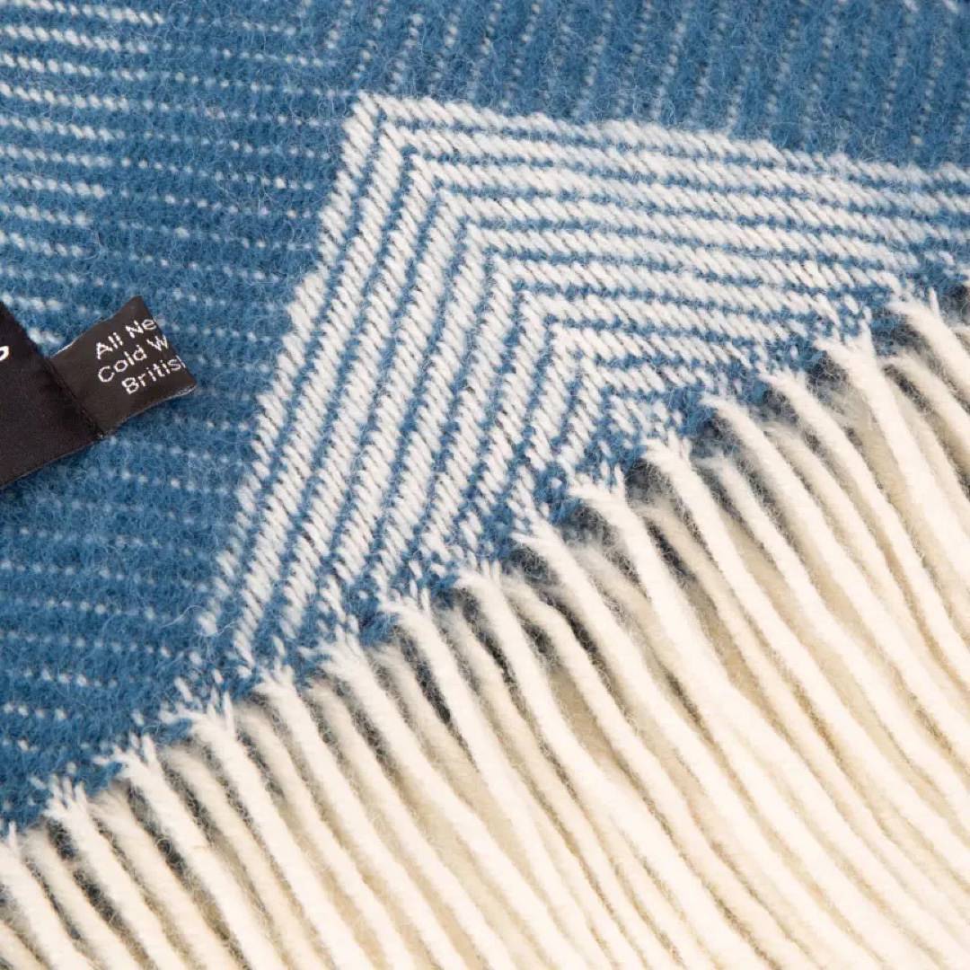 This blue and grey, diamond patterned, cosy and fluffy blanket is made from 100% pure new wool and finished with extra brushing to make it exceptionally soft.
