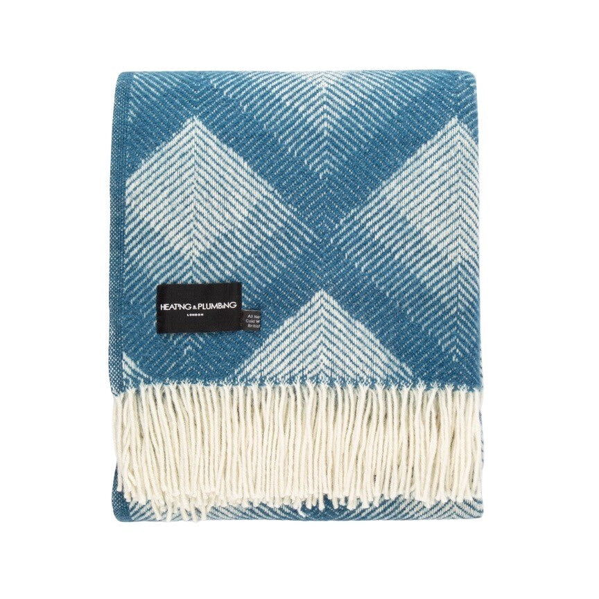 This blue and grey, diamond patterned, cosy and fluffy blanket is made from 100% pure new wool and finished with extra brushing to make it exceptionally soft.