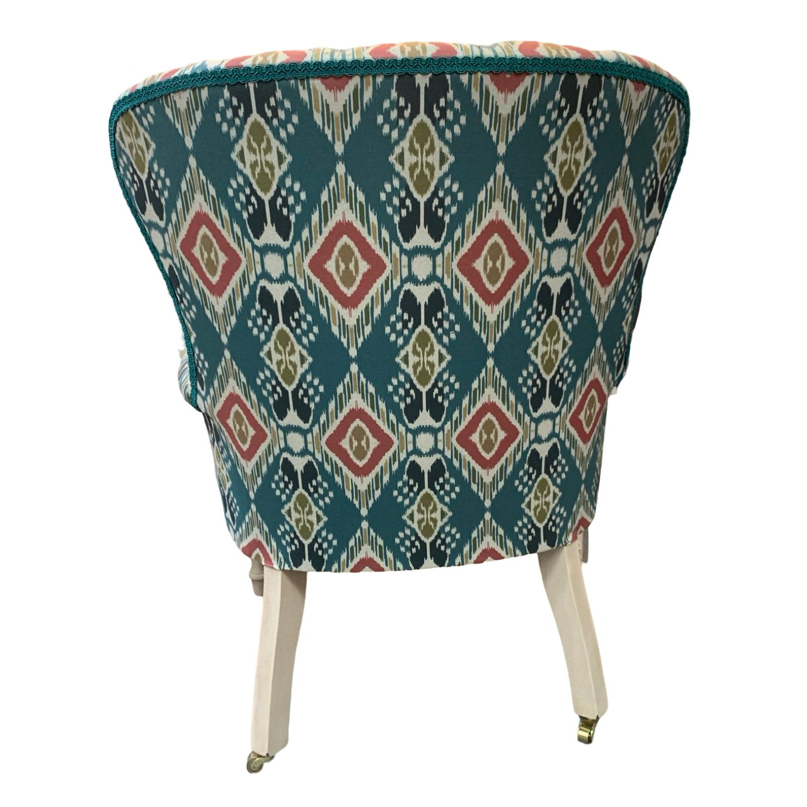 A hand-crafted armchair in blue linen with a red and mustard diamond design. 