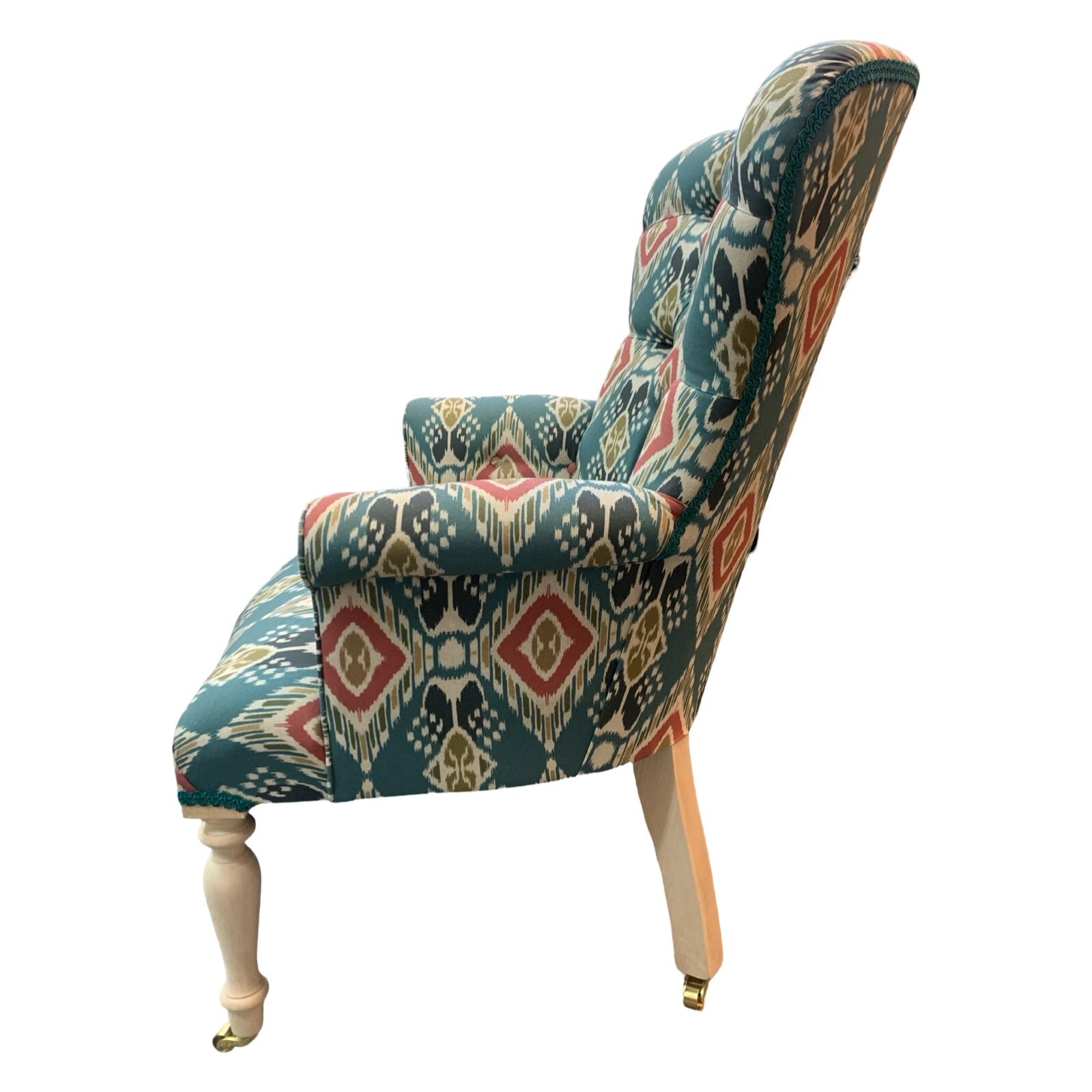 A hand-crafted armchair in blue linen with a red and mustard diamond design. 