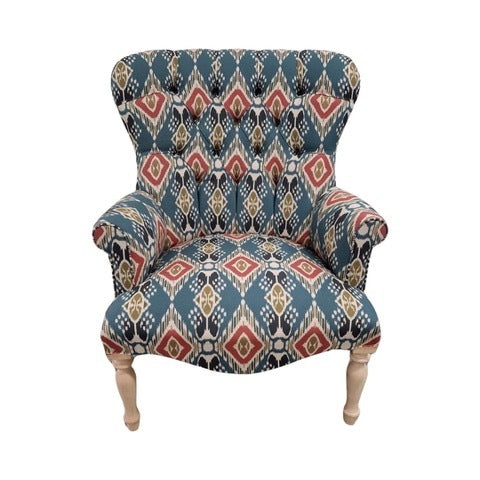 A hand-crafted armchair in blue linen with a red and mustard diamond design. 