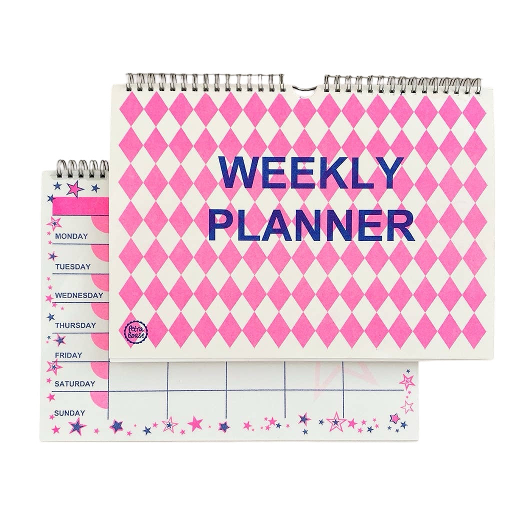 A pink and blue weekly planner with a pink diamond cover