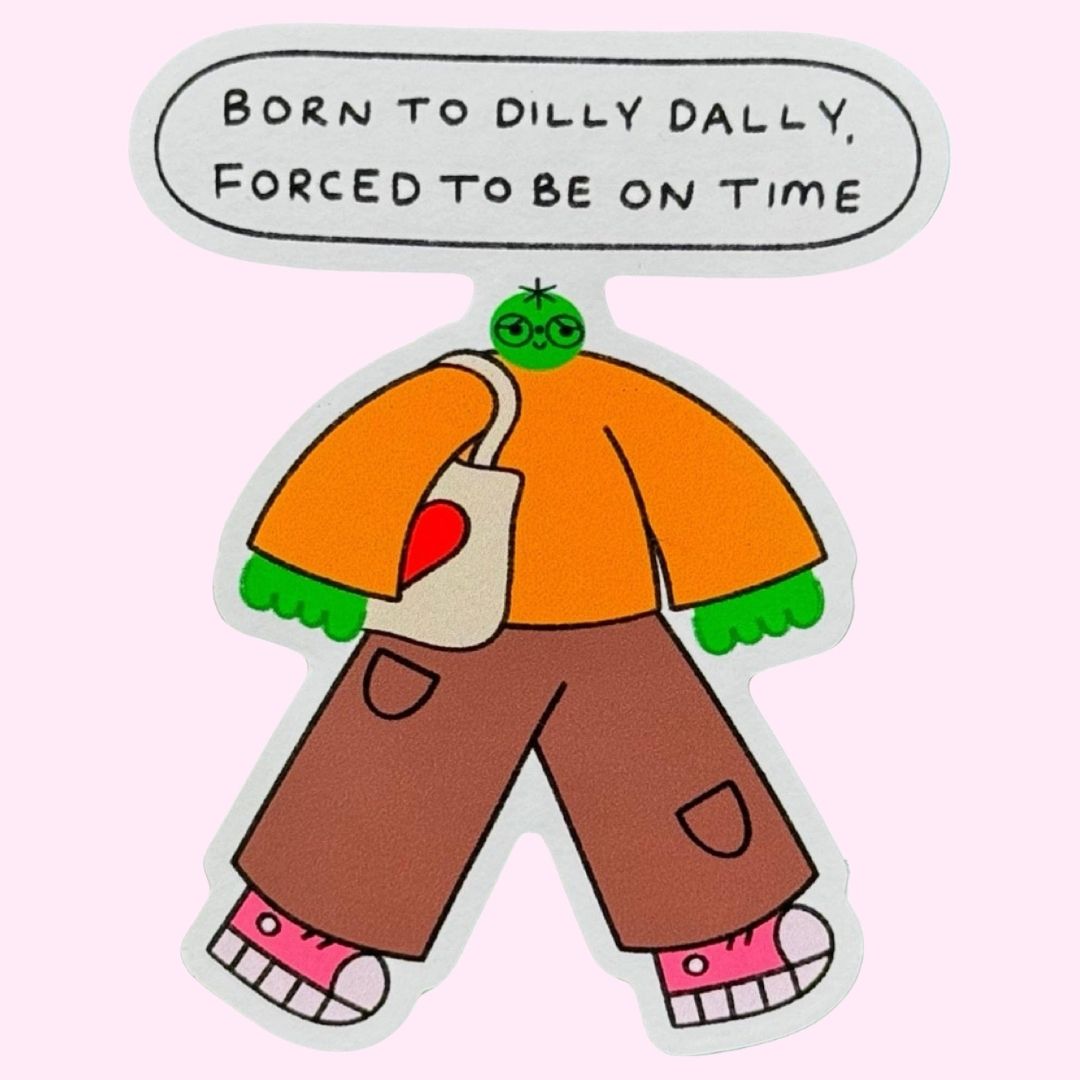 A cartoon-style sticker of a green-skinned character with an orange shirt, brown pants, pink shoes, and a white tote bag, with a speech bubble above reading 'BORN TO DILLY DILLY, FORCED TO BE ON TIME', on a pink background.