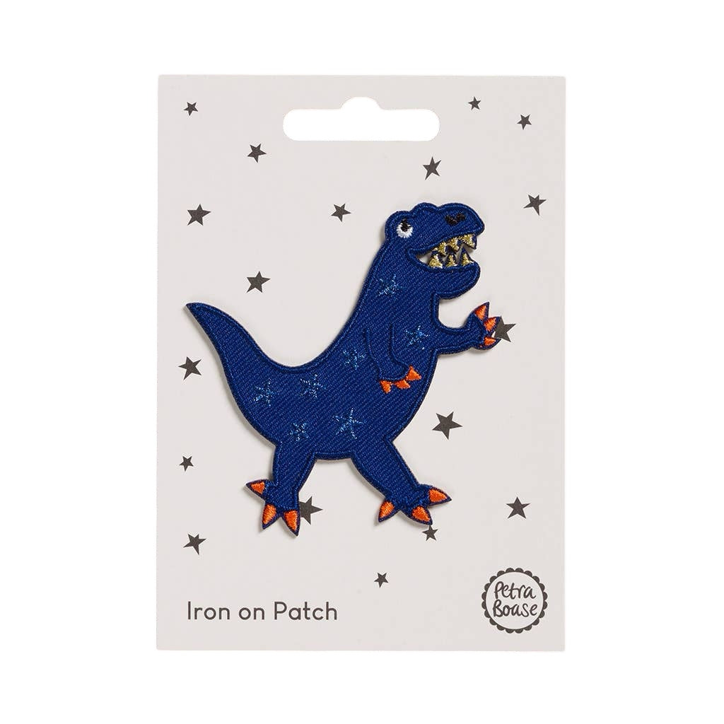 An embroidered dinosaur-shaped fabric of a blue dinosaur with orange fingers and toes.