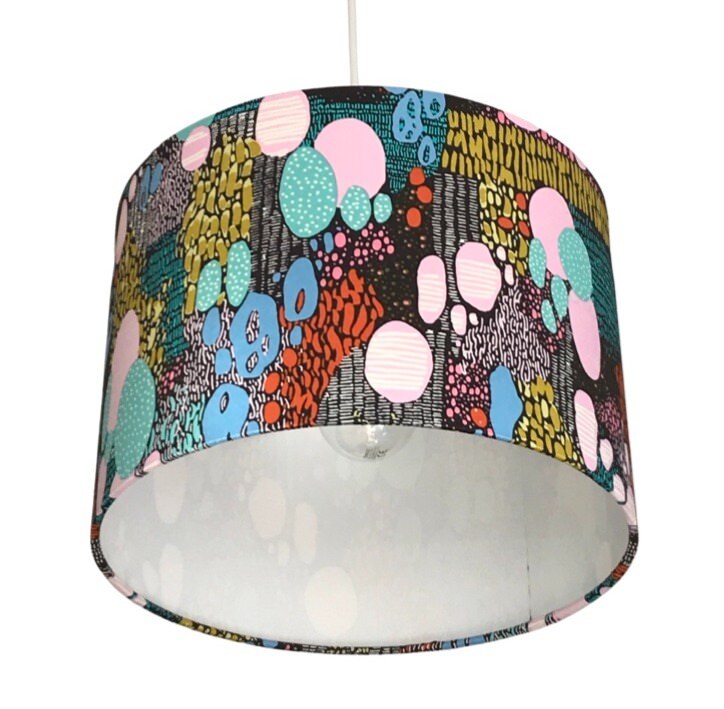 dark brown drum lampshade with multicoloured shapes