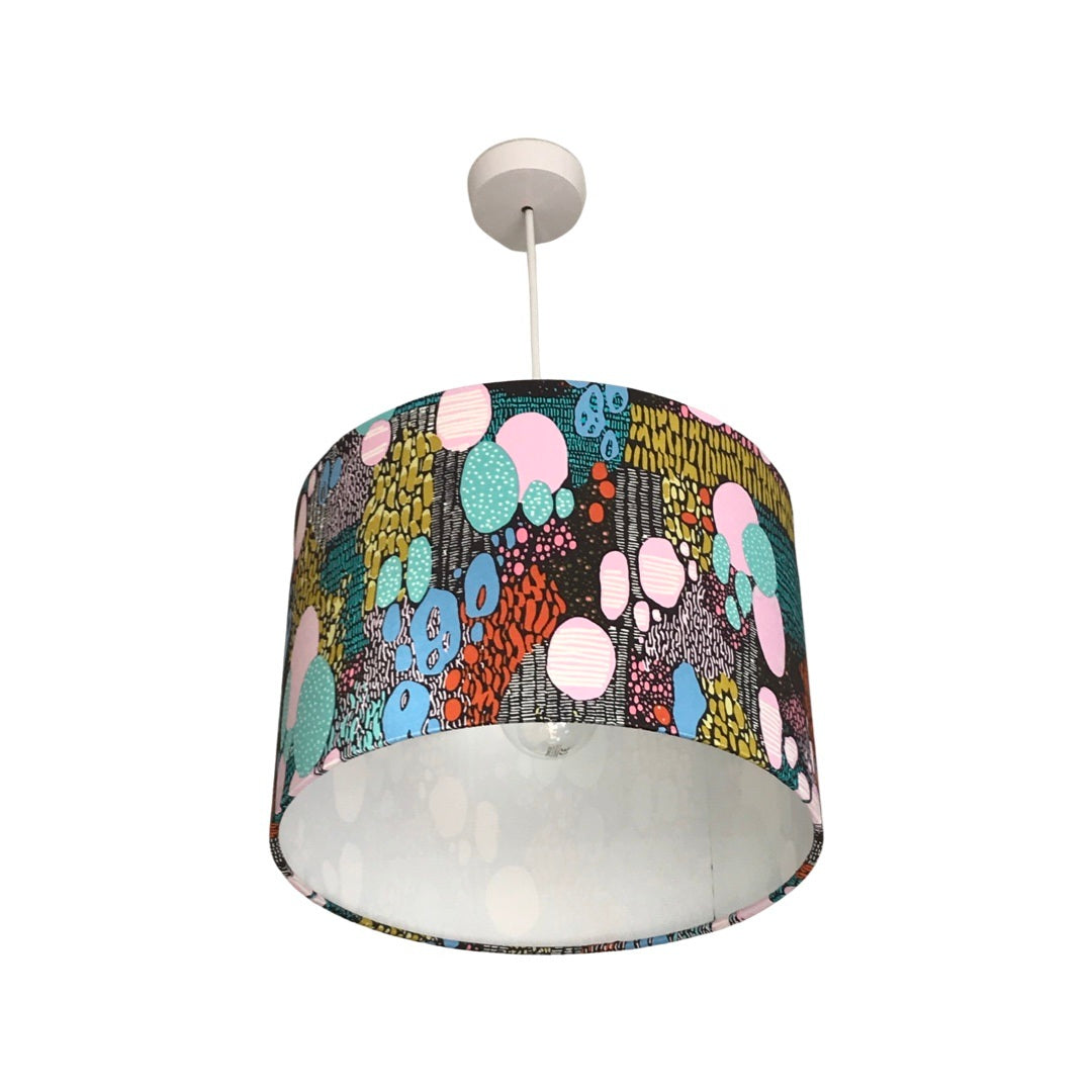 dark brown drum lampshade with multicoloured shapes