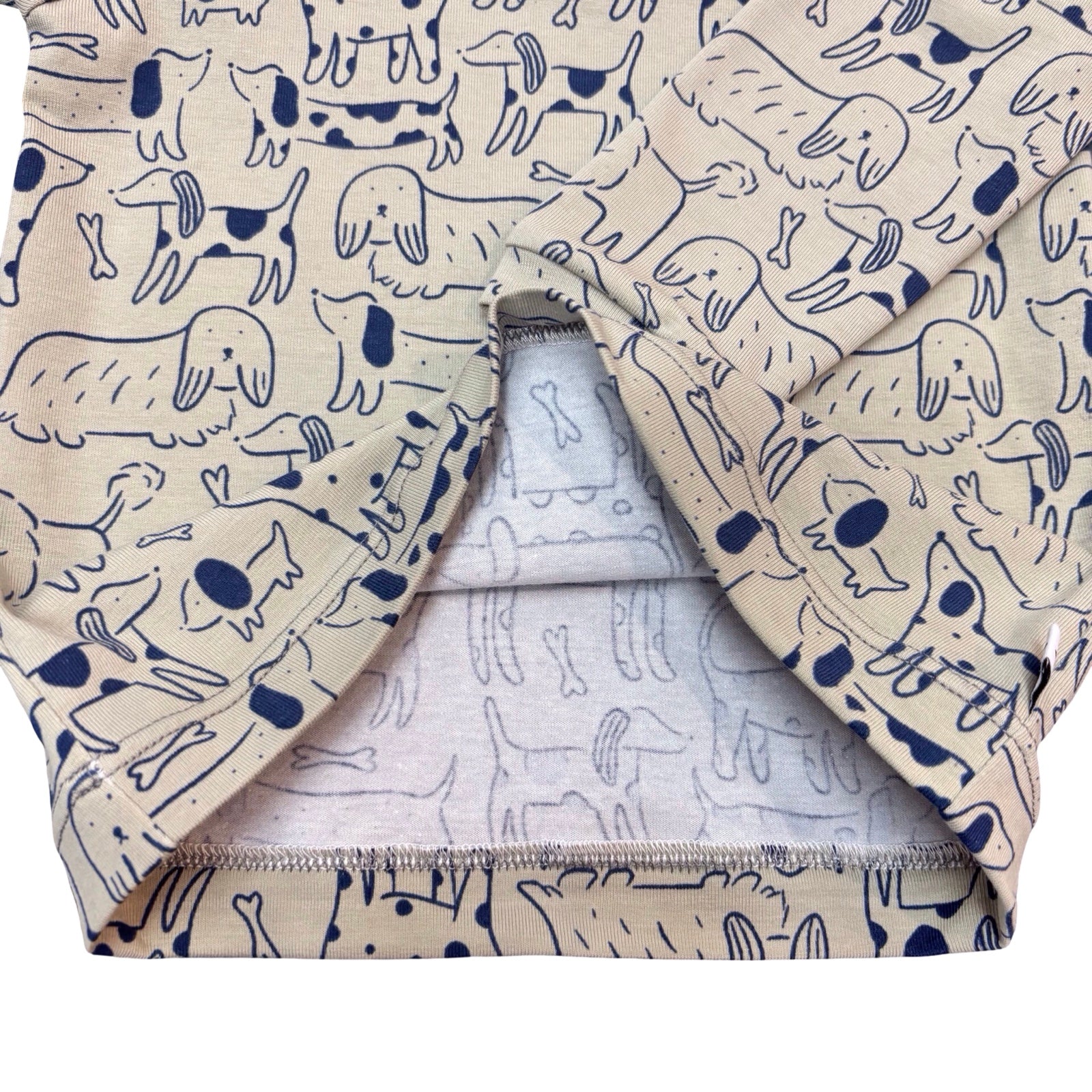 Folded fabric with dog pattern on a white background.