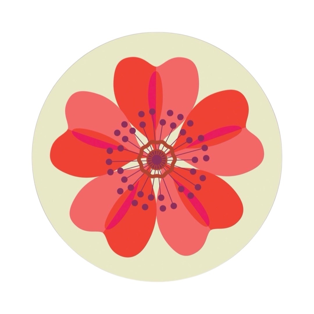 A round placemat featuring a dog rose flower abstract design in red and white.
