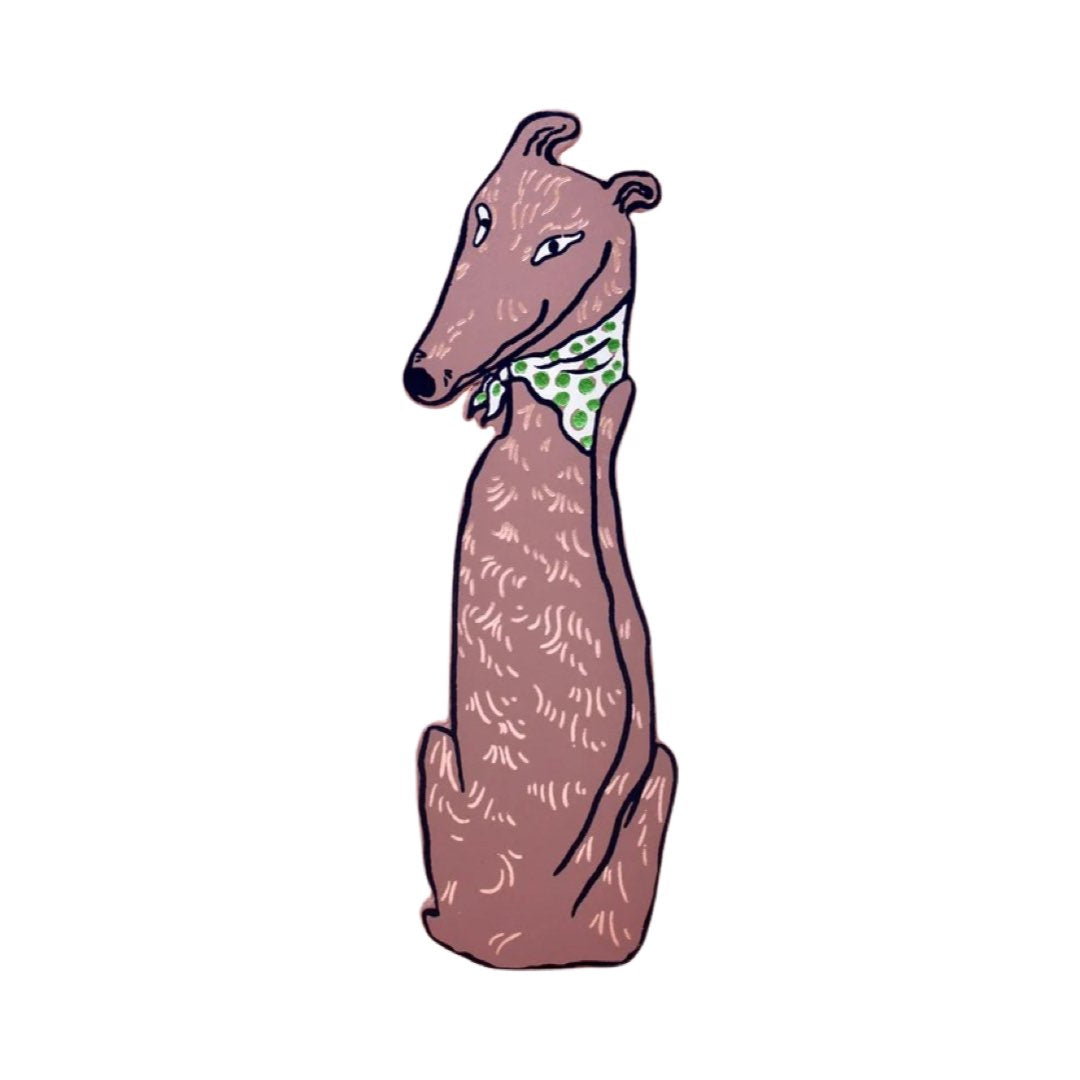 A brown dog-shaped leather bookmark wearing a green and white spotty bandana.