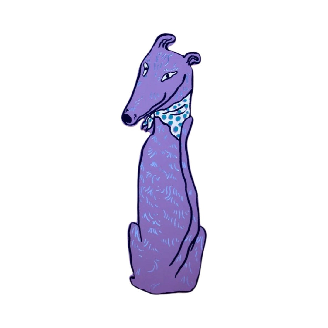 A lilac dog-shaped leather bookmark wearing a blue and white spotty bandana.