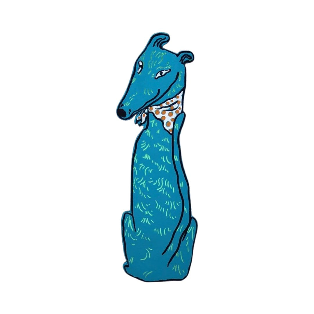 A turquoise dog-shaped leather bookmark wearing a brown and white spotty bandana.