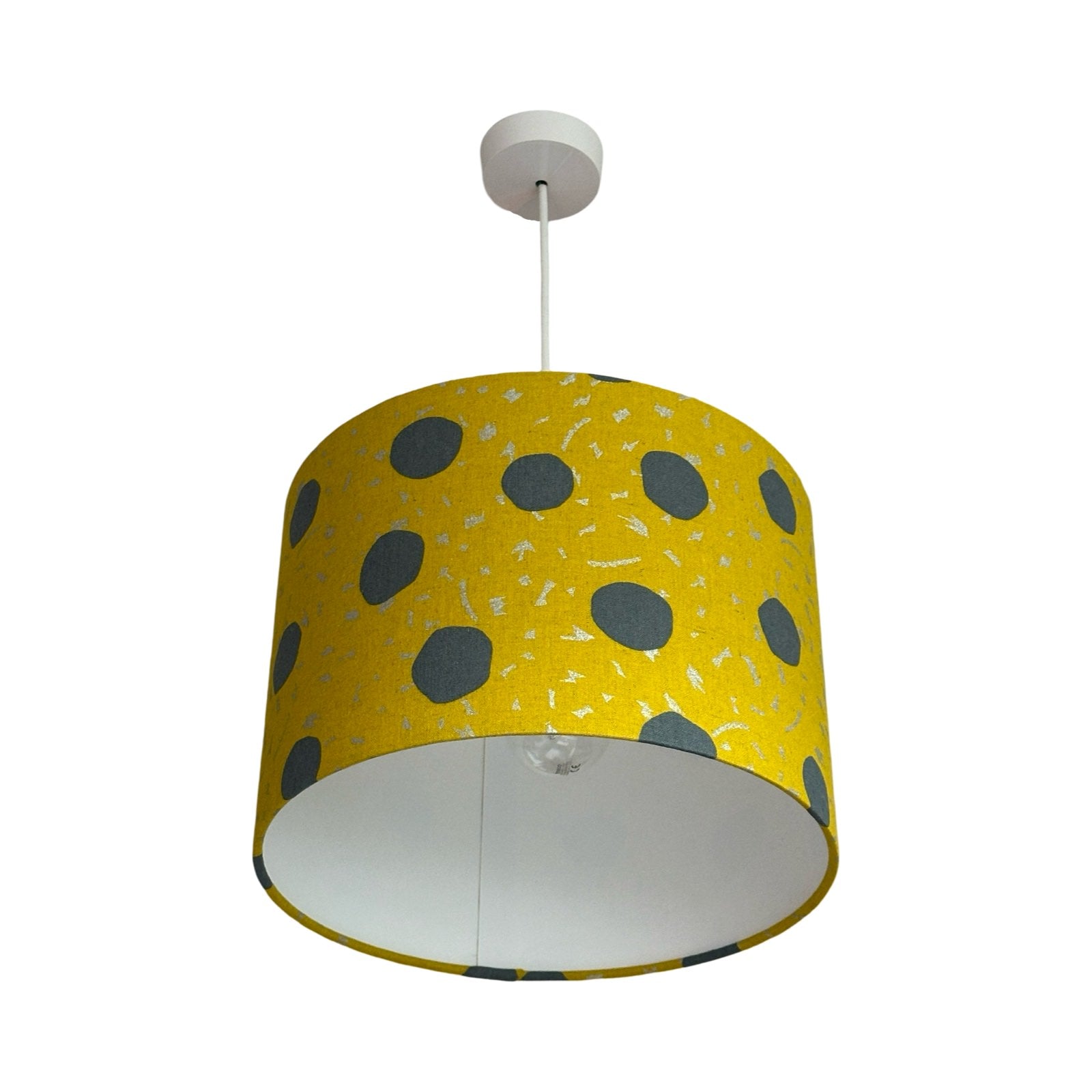 Mustard drum lampshade with large grey spots and silver dashes