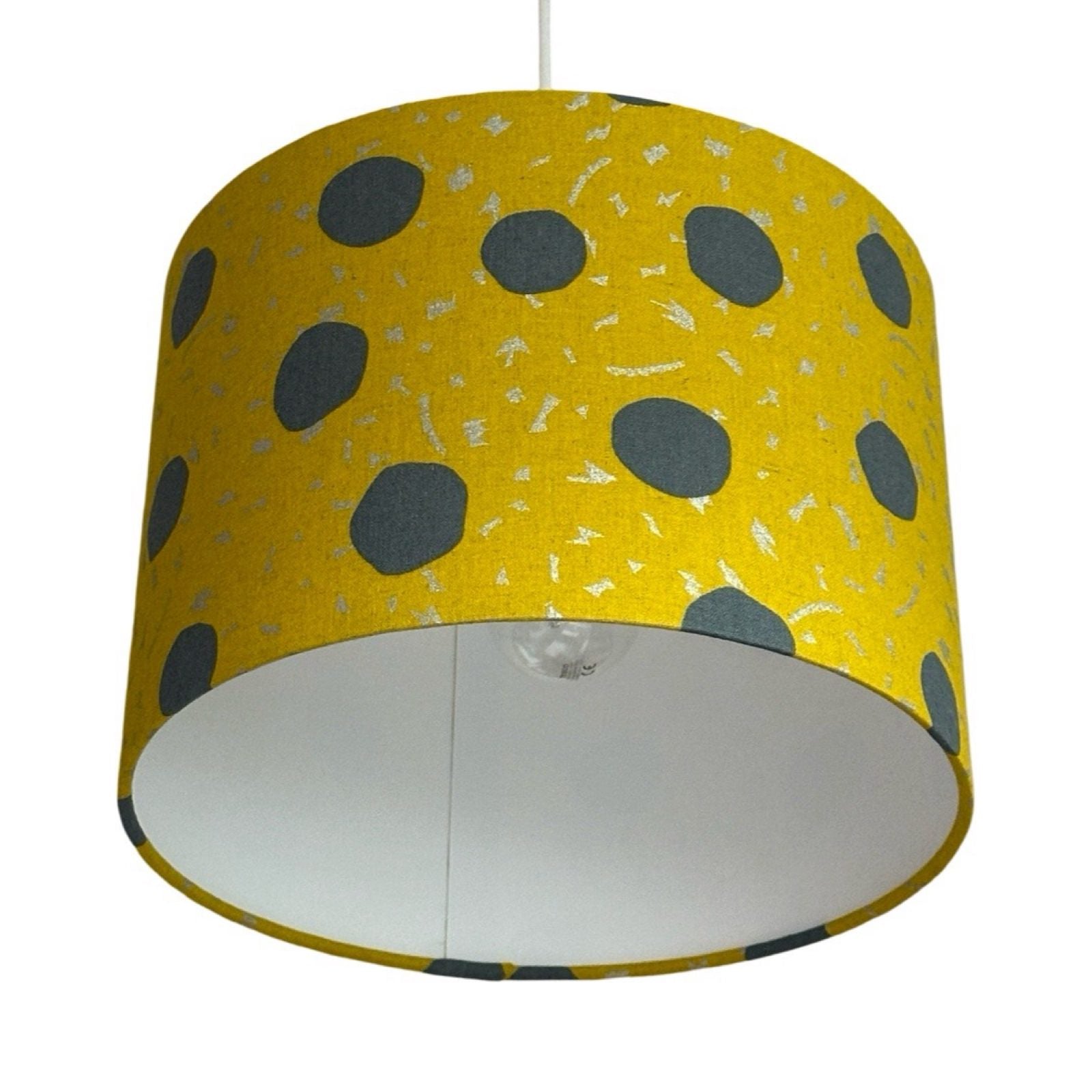 Mustard drum lampshade with large grey spots and silver dashes
