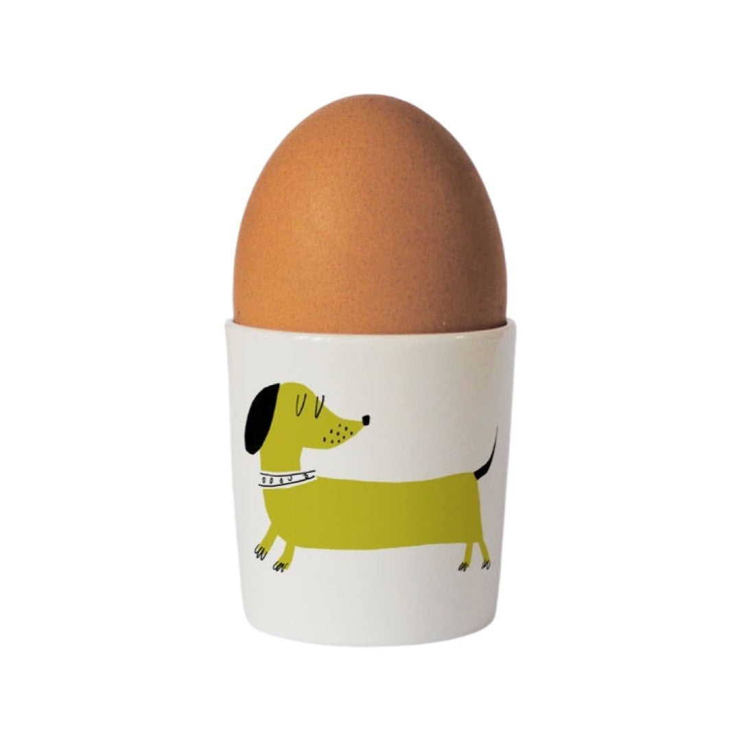 Bone china egg cup with an illustration of a lime green sausage dog on the front.