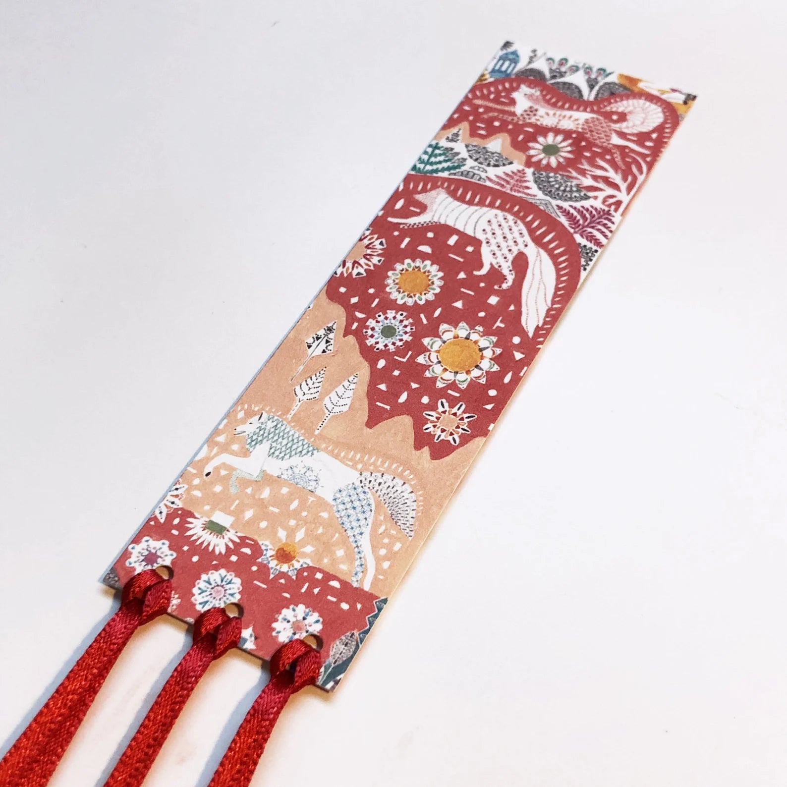Decorative headband with animal and floral pattern on a white background.