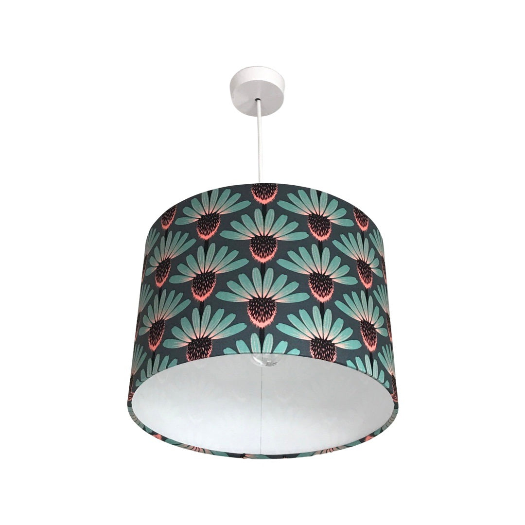 drum lampshade with teal, brown and pink echinacea flowers on a teal background.