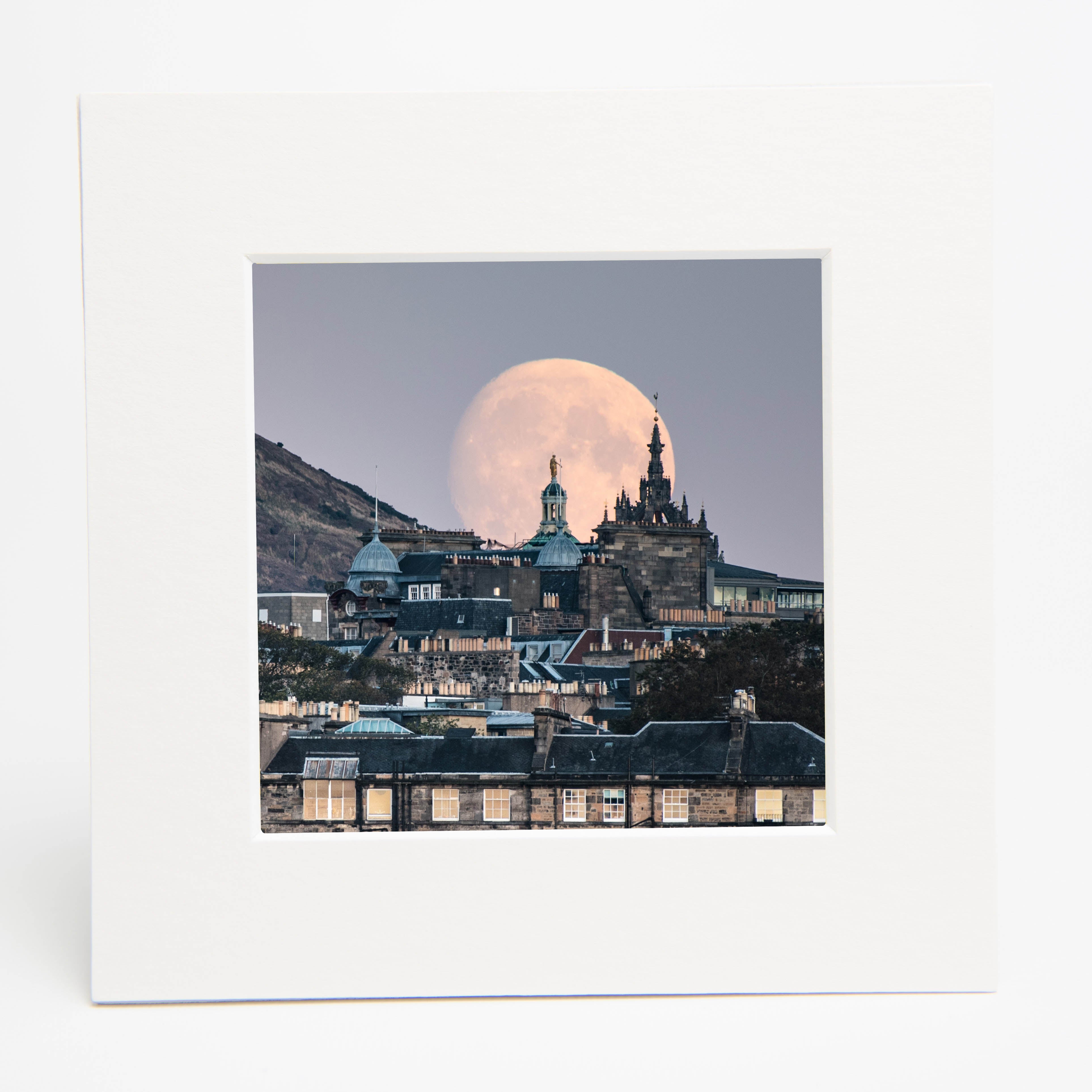 An image of a moonrise in a white square mount. 