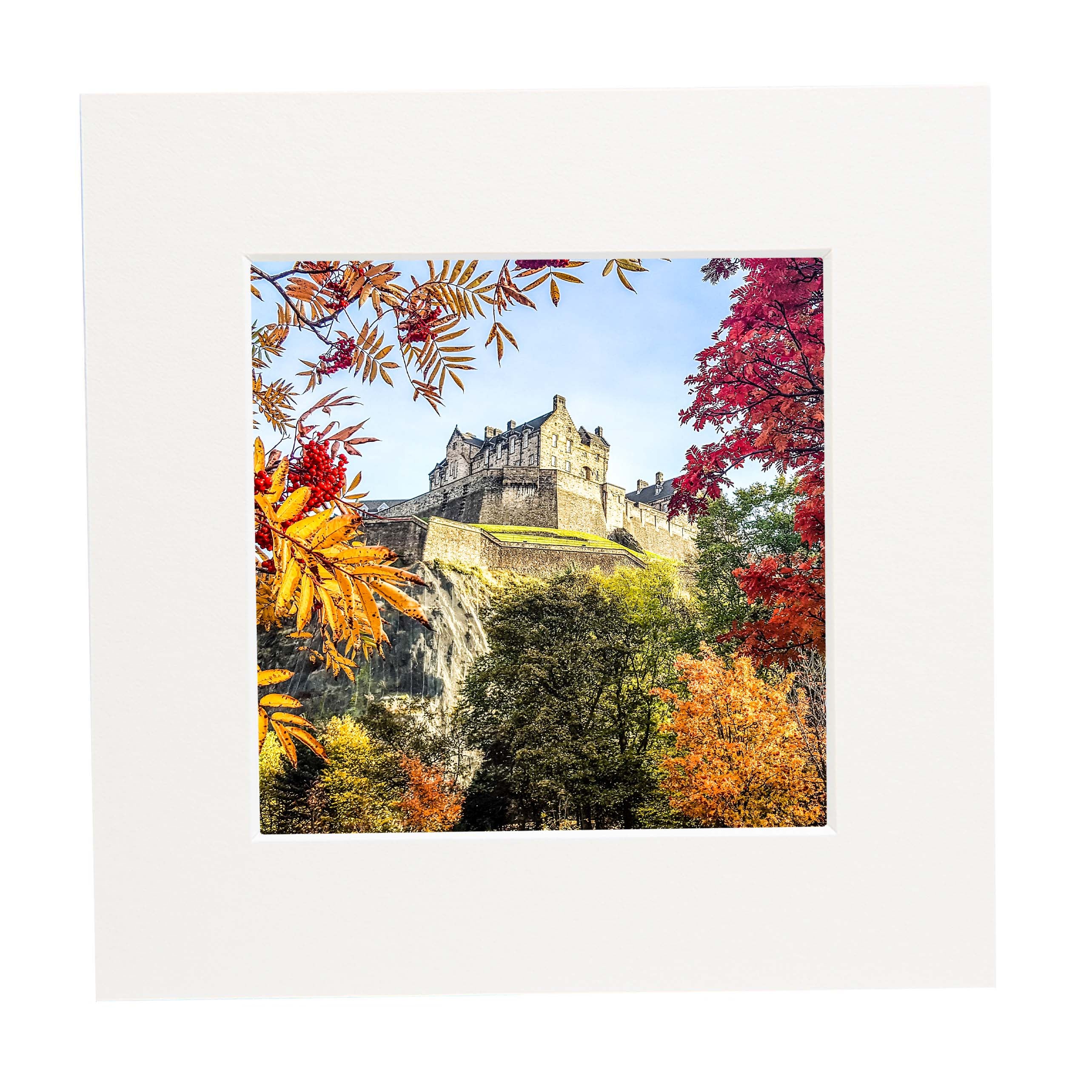 An image of Edinburgh Castle surrounded by autumn leaves in a mount. 